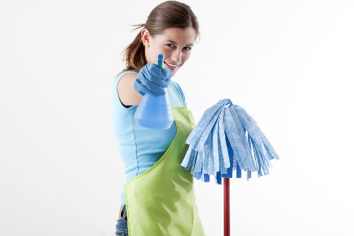 Carpet cleaning technician working safely in a Wimbledon property