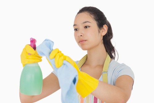Professional cleaner in Wimbledon preparing a spotless living room